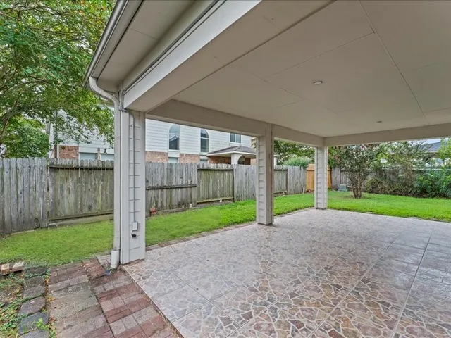 a view of a house with backyard and porch