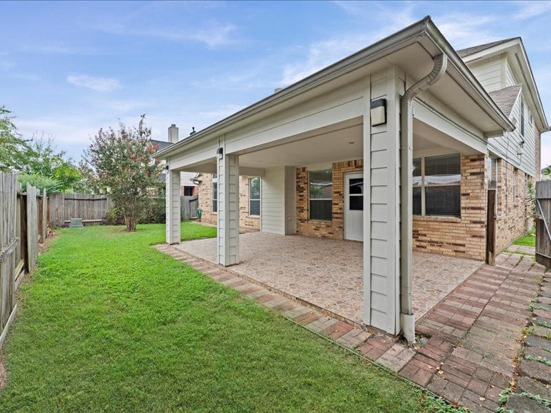 3323 Sainte Mere Eglise Lane Spring, TX 77388 - Photo 32 of 33 a view of a house with backyard and porch