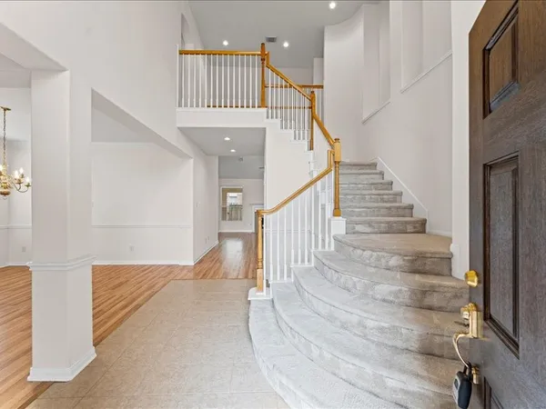 a view of entryway and hall with wooden floor