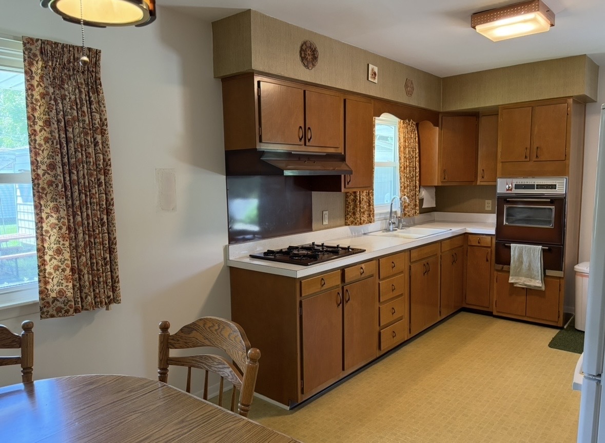 609 9th Avenue Ottawa, IL 61350 - Photo 13 of 28 a kitchen with a stove a sink and a microwave