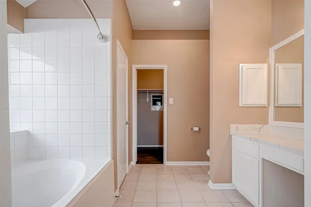 a bathroom with a bathtub and a shower