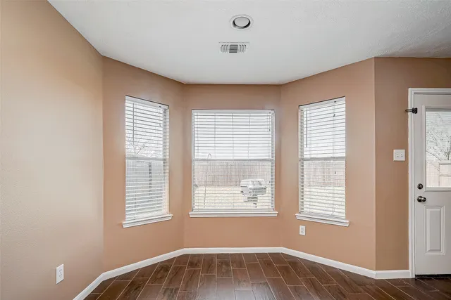 a view of an empty room with a window