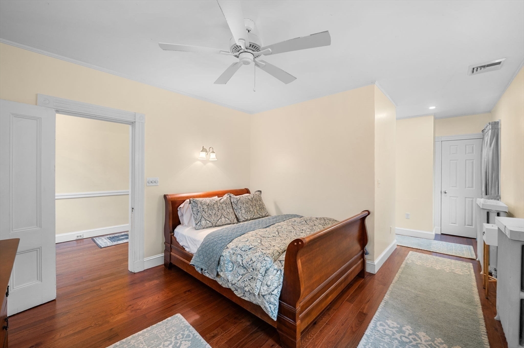 5 Beacon Street Danvers, MA 01923 - Photo 16 of 37 a bedroom with a bed and a ceiling fan