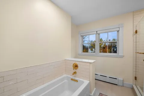 a bathroom with a bathtub and window
