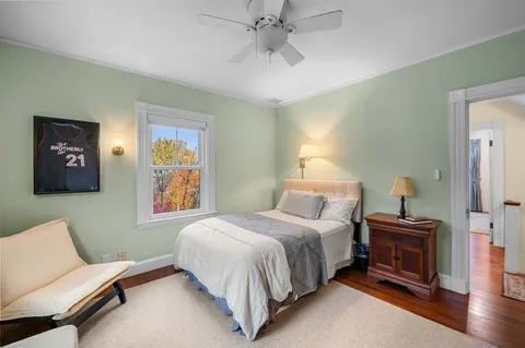 a bedroom with a bed and ceiling fan