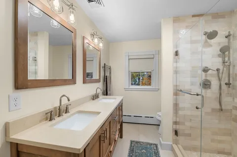 a bathroom with a sink double vanity and a shower
