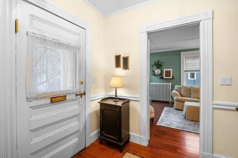 a view of living room with furniture and wooden floor