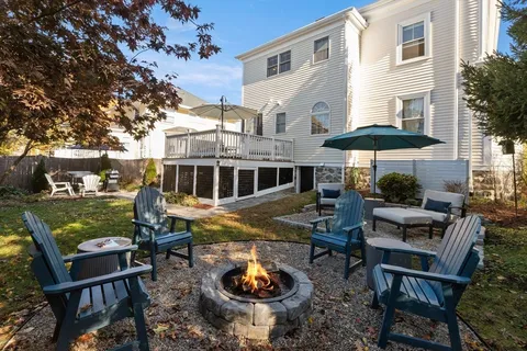 a view of a house with backyard water fountain and sitting area