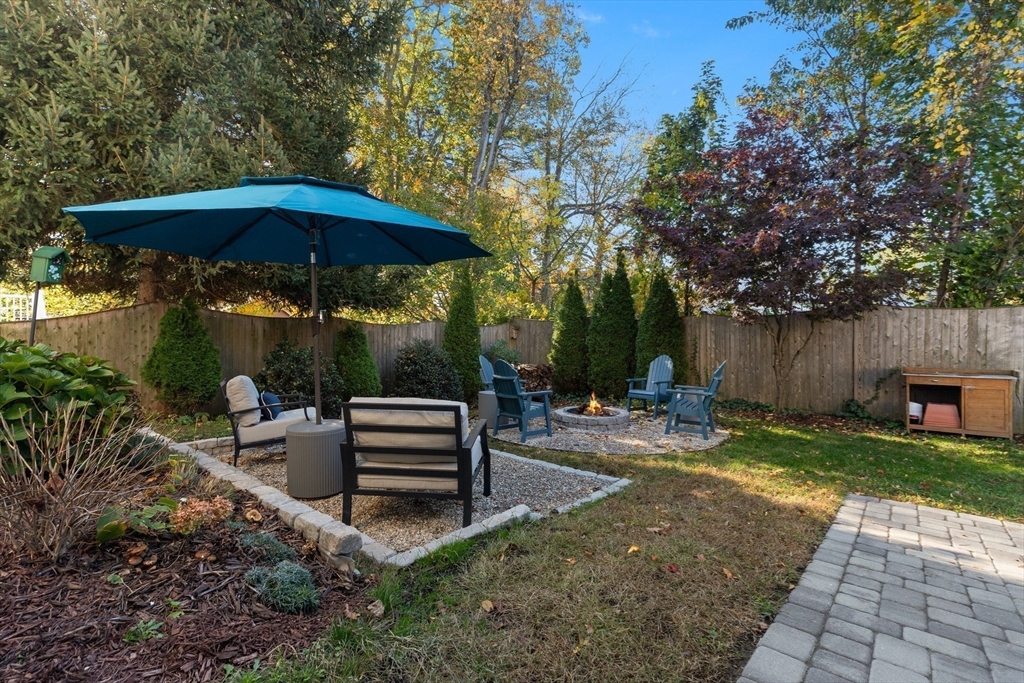 5 Beacon Street Danvers, MA 01923 - Photo 32 of 37 a view of a table and chairs under an umbrella in the backyard