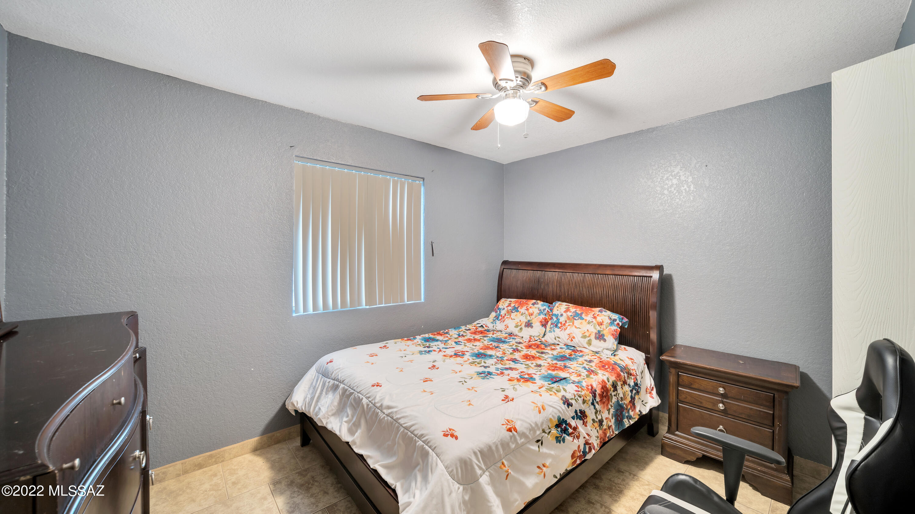 434 Paseo Flamenco Rio Rico, AZ 85648 - Photo 15 of 27 a bedroom with a bed and a chandelier