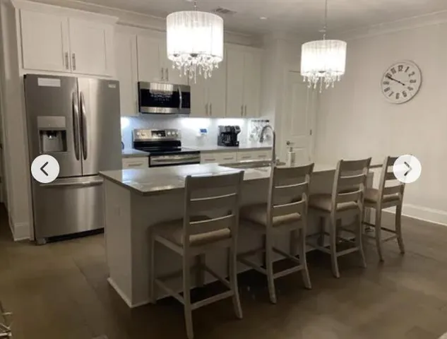 a kitchen with a dining table and chairs