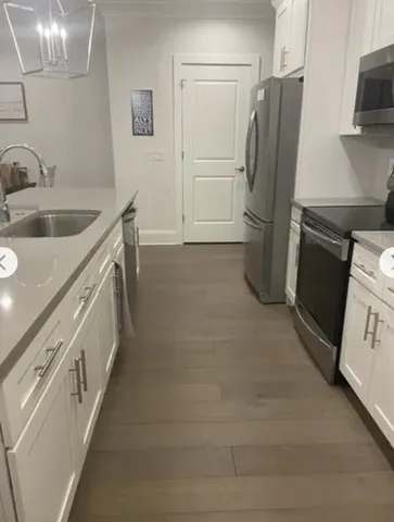 a kitchen with a refrigerator and a sink