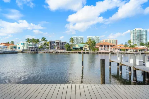 a view of a lake with boats and trees in the background