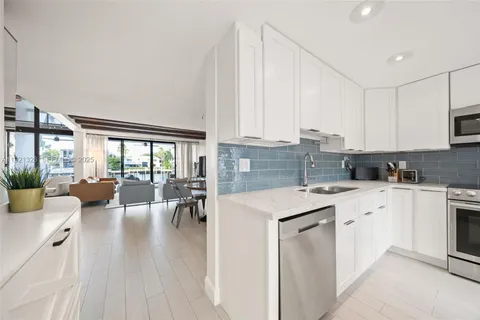 a kitchen with a sink cabinets and wooden floor