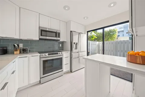 a kitchen with a sink stove and microwave