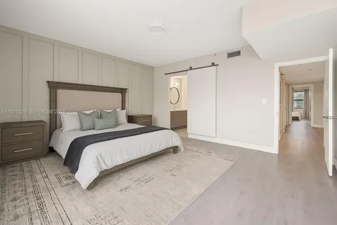 a bedroom with a bed and a walk in closet
