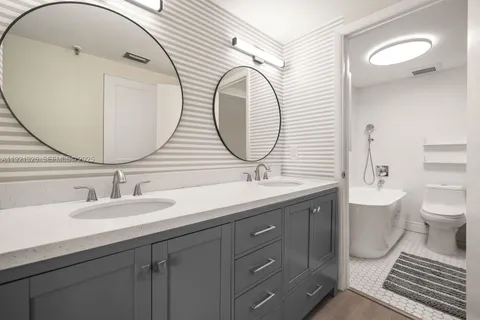 a bathroom with a toilet a sink and mirror