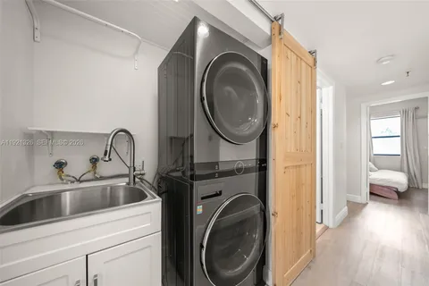 a kitchen with a sink and a washer dryer