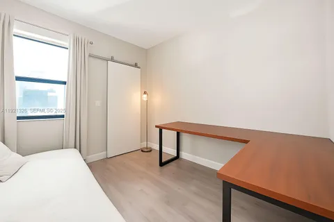 a bedroom with a bed and a night stand