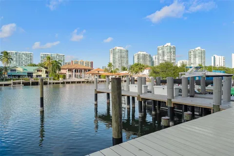 a view of a lake with boats and trees in the background