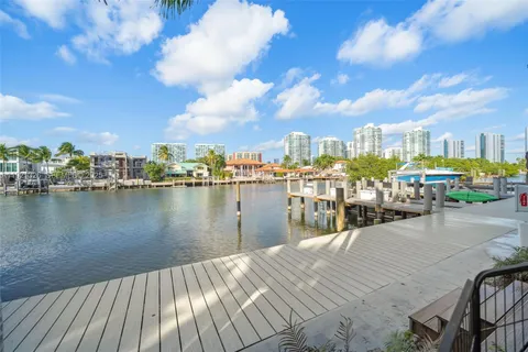 a view of a lake with boats and trees in the background
