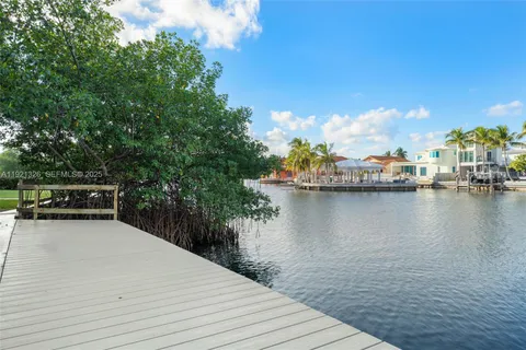 a view of a lake with couches chairs