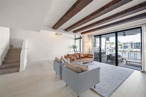 a living room with furniture and large windows