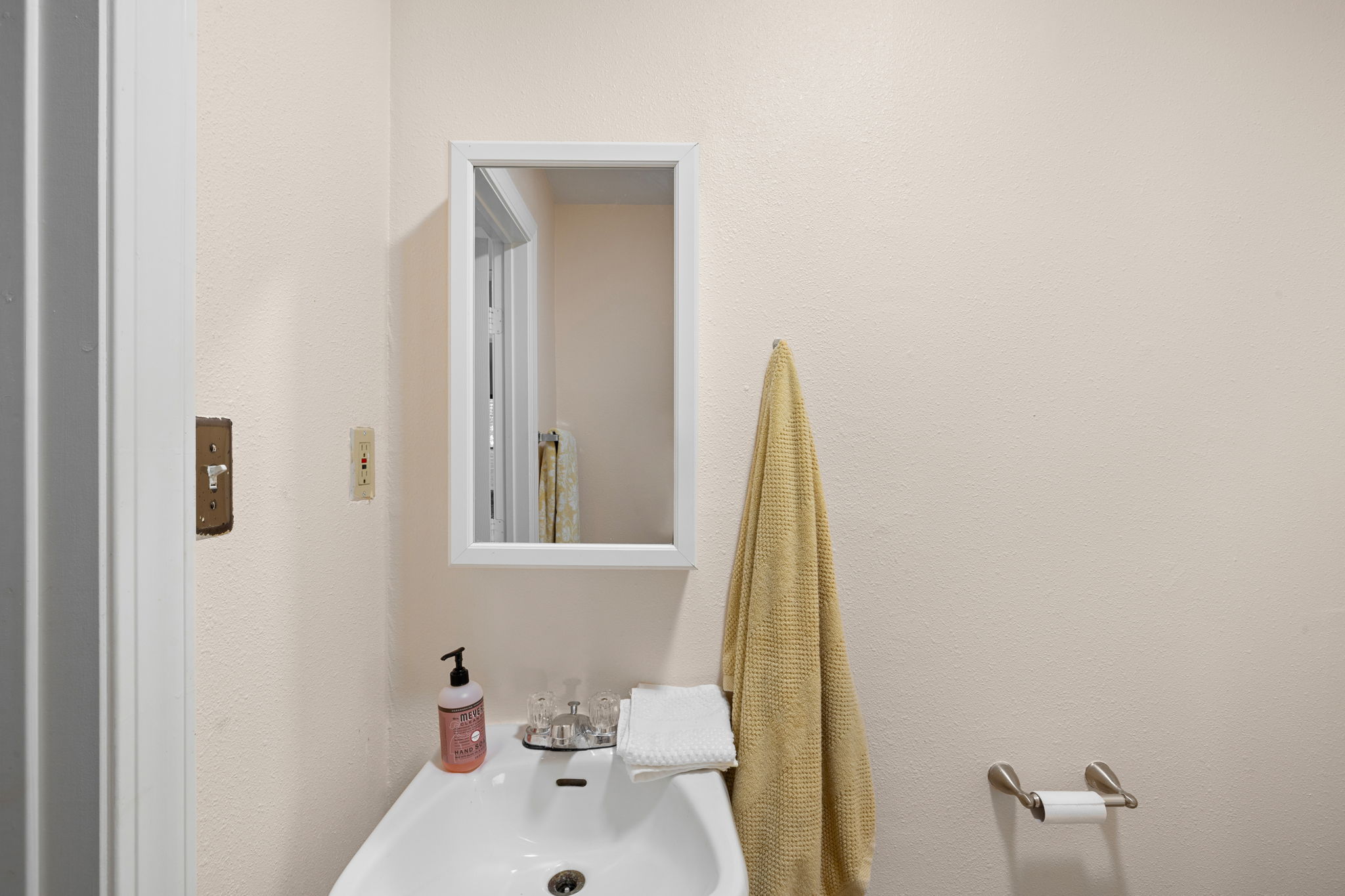 907 East 53rd Street Austin, TX 78751 - Photo 23 of 36 A well-appointed bathroom with a sleek sink and mirror for everyday convenience.