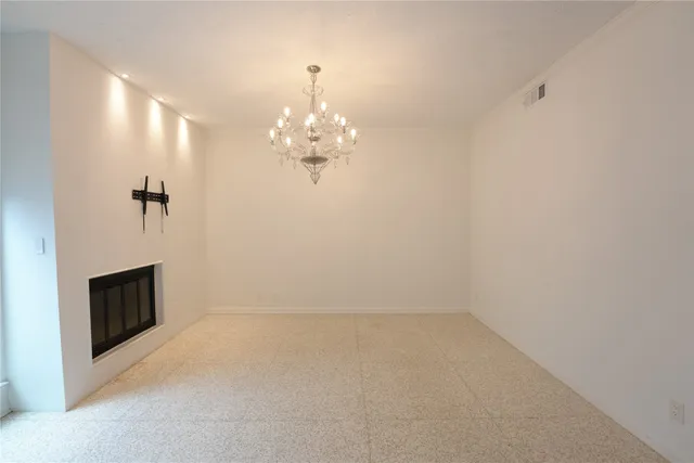 a view of a chandelier in big room and chandelier