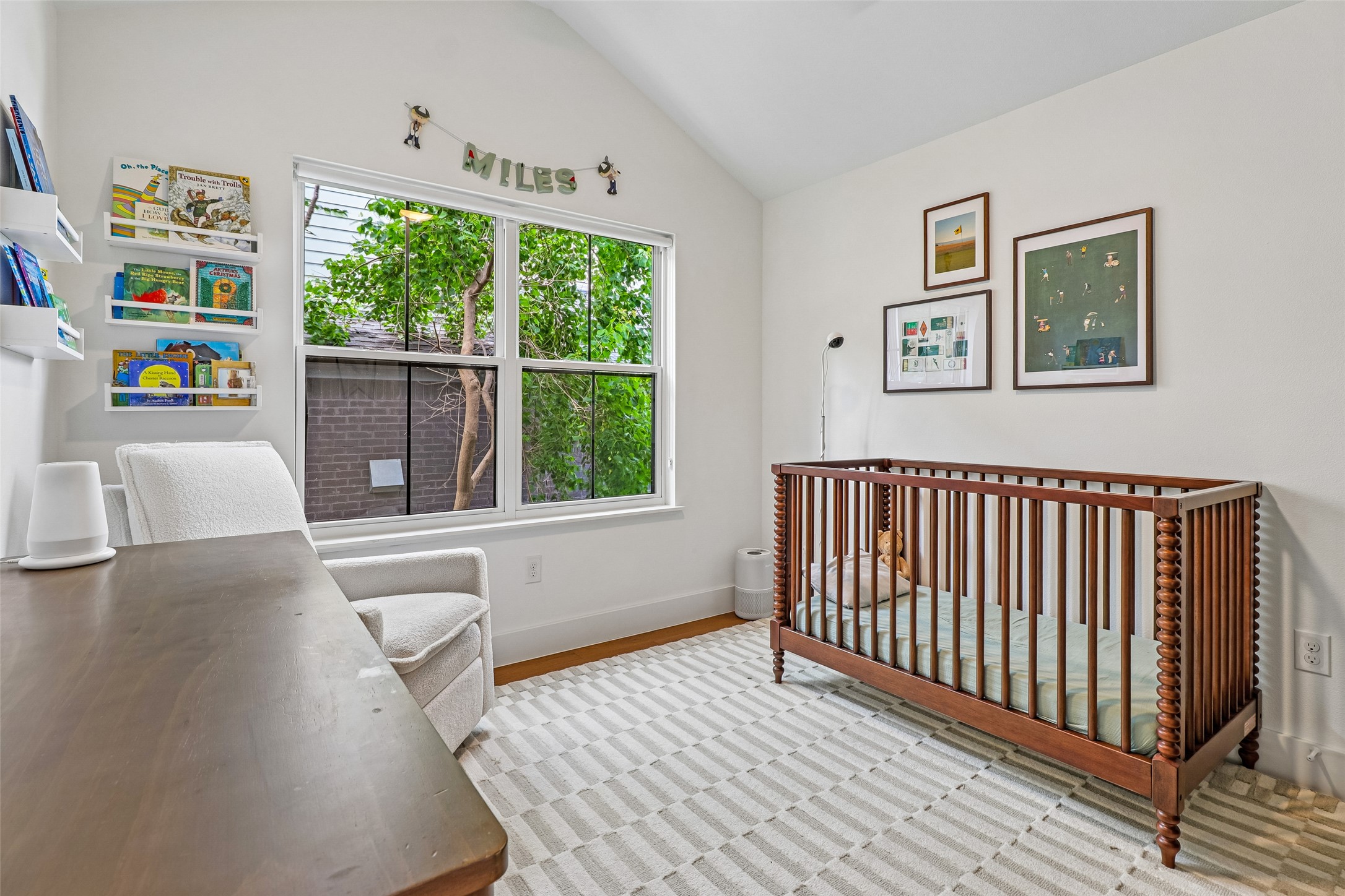 1706 Perez Street, Unit 1 Austin, TX 78721 - Photo 29 of 36 A well-lit nursery features vaulted ceilings and ample natural light through a large window.