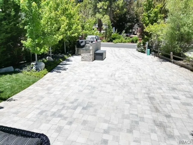 a view of a terrace with a bench and trees