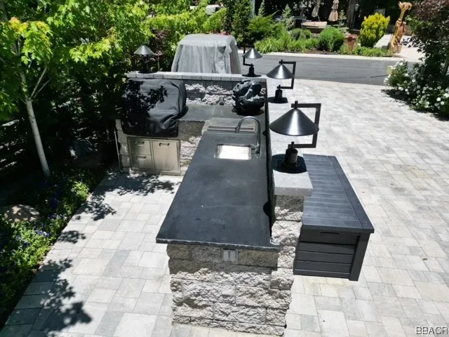 a view of a patio with table and chairs with wooden fence and plants