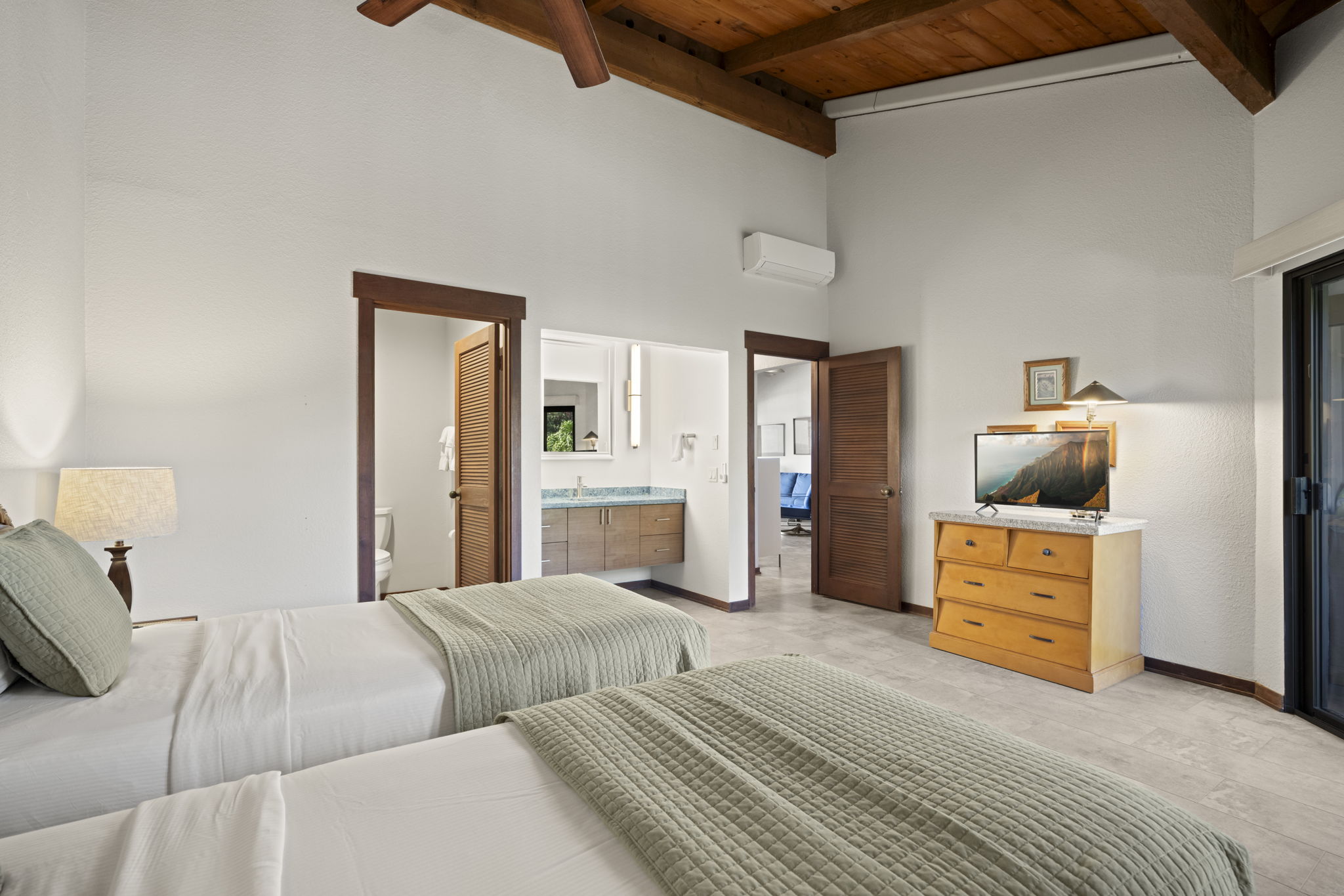 1870 Hoone Road, Unit 831 Koloa, HI 96756 - Photo 12 of 30 a bedroom with a bed and a cabinets