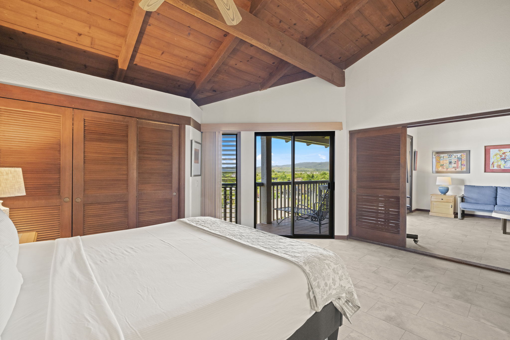 1870 Hoone Road, Unit 831 Koloa, HI 96756 - Photo 15 of 30 a bedroom with a large bed and a large window