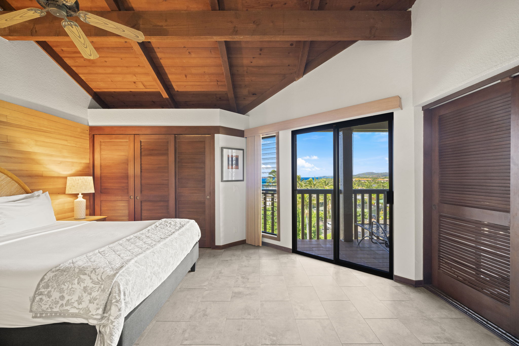 1870 Hoone Road, Unit 831 Koloa, HI 96756 - Photo 16 of 30 a bedroom with a large bed and a large window