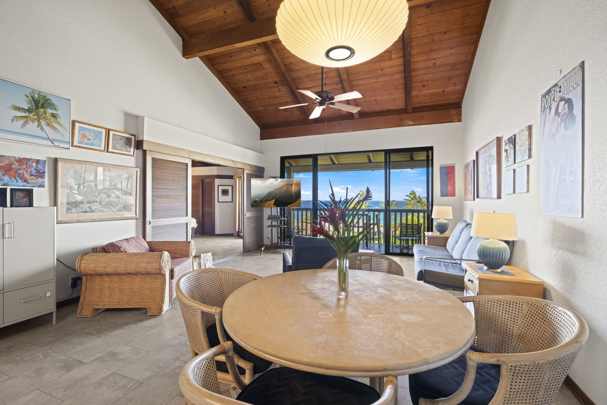 1870 Hoone Road, Unit 831 Koloa, HI 96756 - Photo 4 of 30 a living room with furniture a chandelier and a fireplace