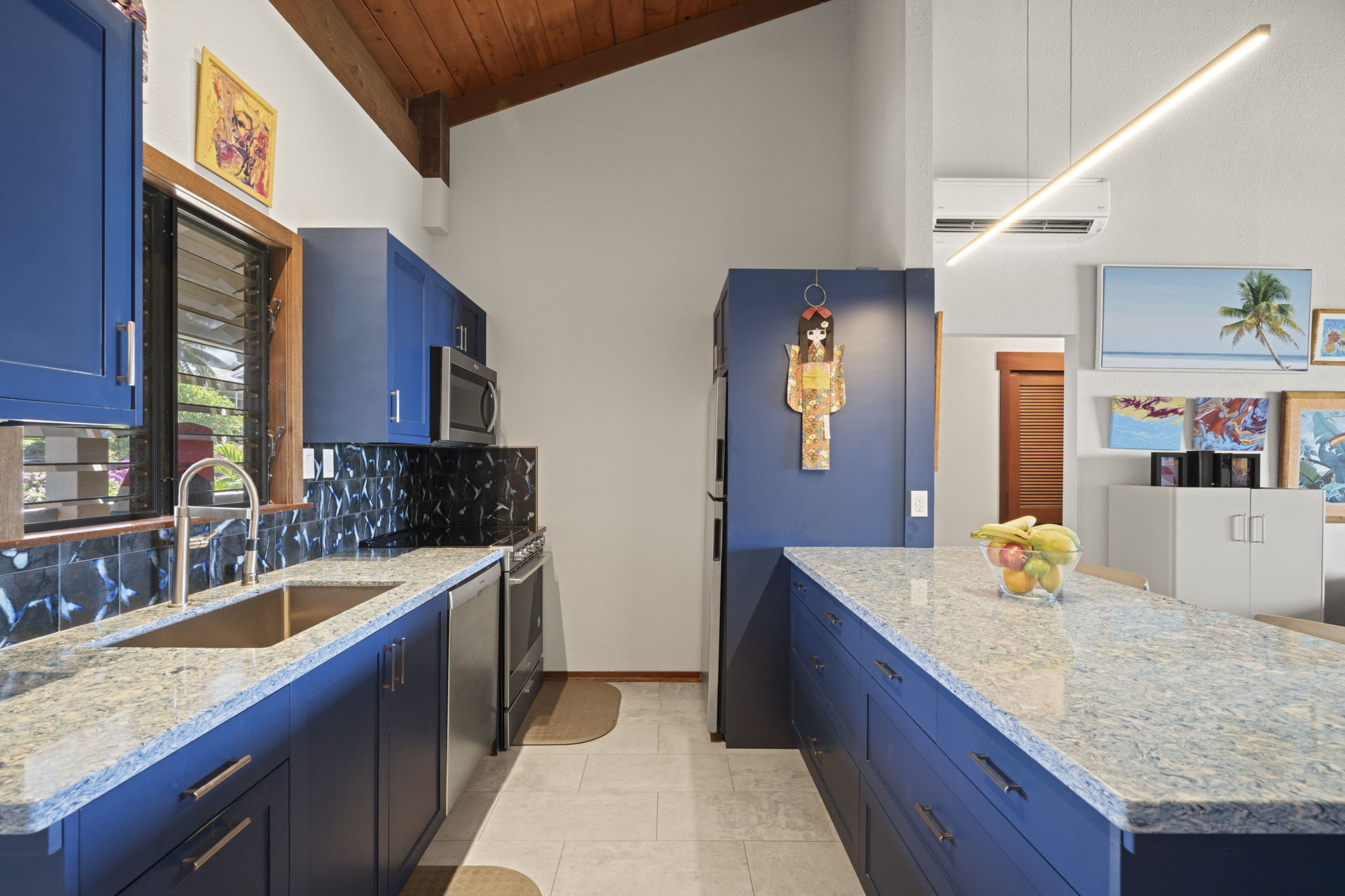 1870 Hoone Road, Unit 831 Koloa, HI 96756 - Photo 6 of 30 a kitchen with stainless steel appliances granite countertop wooden cabinets a sink and dishwasher