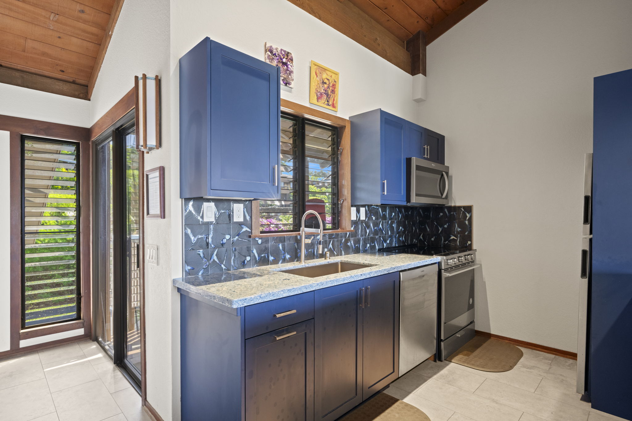 1870 Hoone Road, Unit 831 Koloa, HI 96756 - Photo 8 of 30 a kitchen with stainless steel appliances granite countertop a sink and a refrigerator