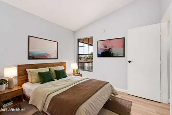 a bedroom with a bed and a window