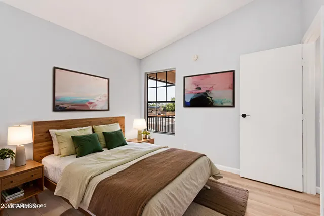 a bedroom with a bed and a window