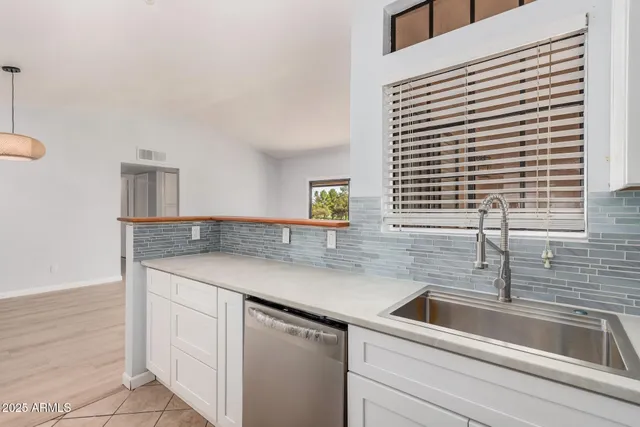 a kitchen with a sink and cabinets