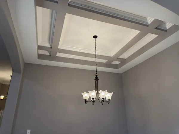 a view of a chandelier and window in the room