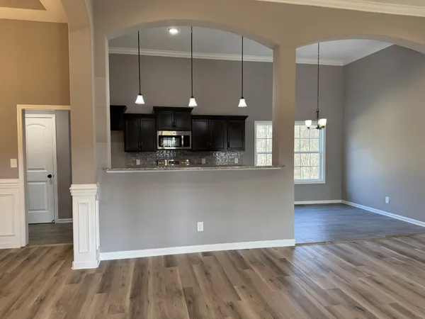 a view of kitchen with cabinets and wooden floor