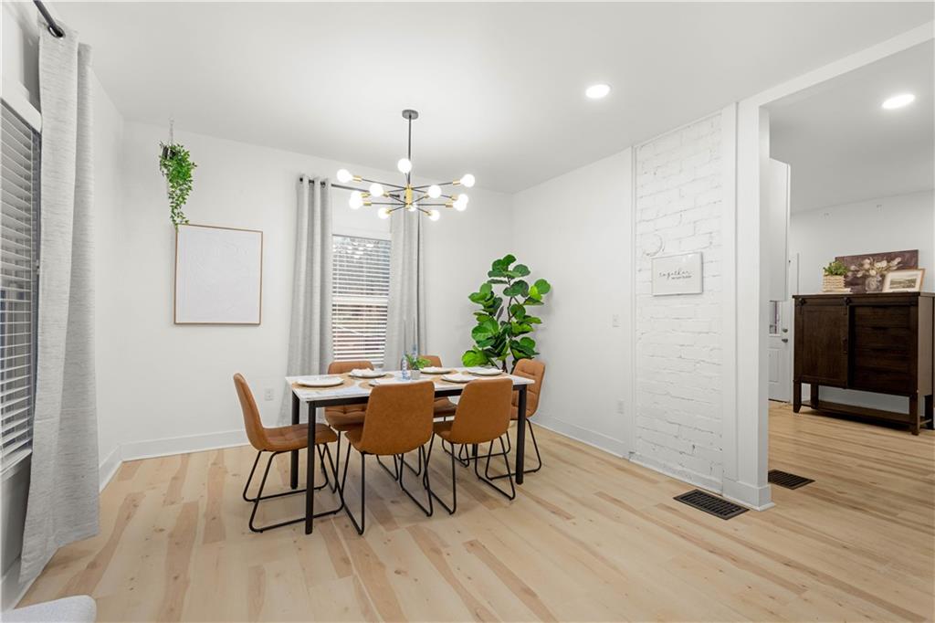 285 Patterson Avenue Bridgeville, PA 15017 - Photo 14 of 33 Spacious dining room is filled with gorgeous natural light, LVP flooring and an exposed brick detail to add original charm.