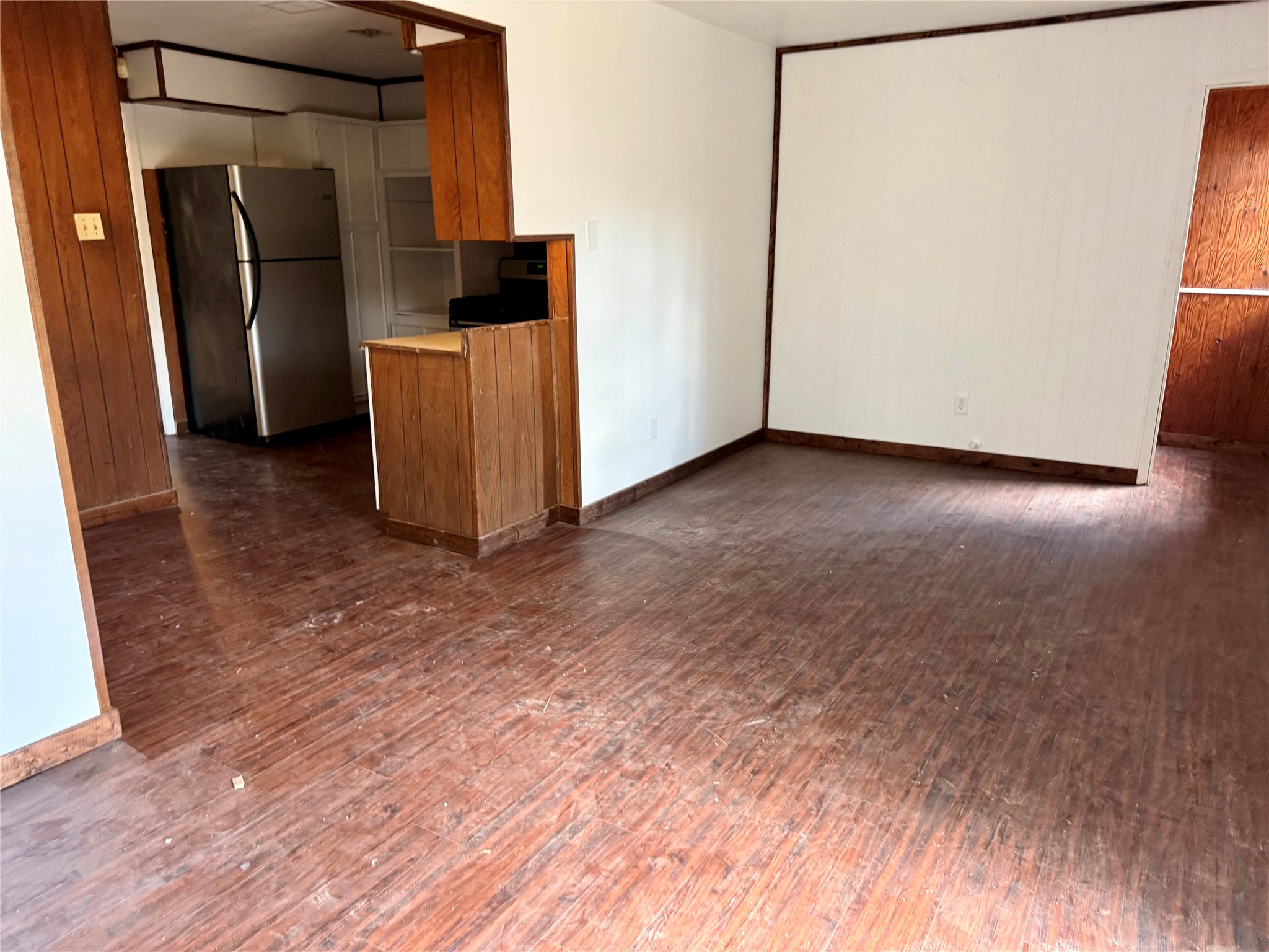 5326 Wenda Street Houston, TX 77033 - Photo 2 of 9 a view of a refrigerator in kitchen and an empty room
