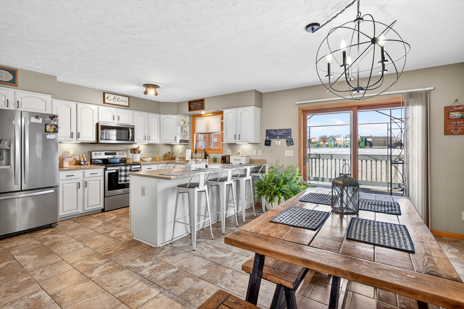 2712 North 13th Street Clinton, IA 52732 - Photo 13 of 47 a open kitchen with white cabinets and stainless steel appliances