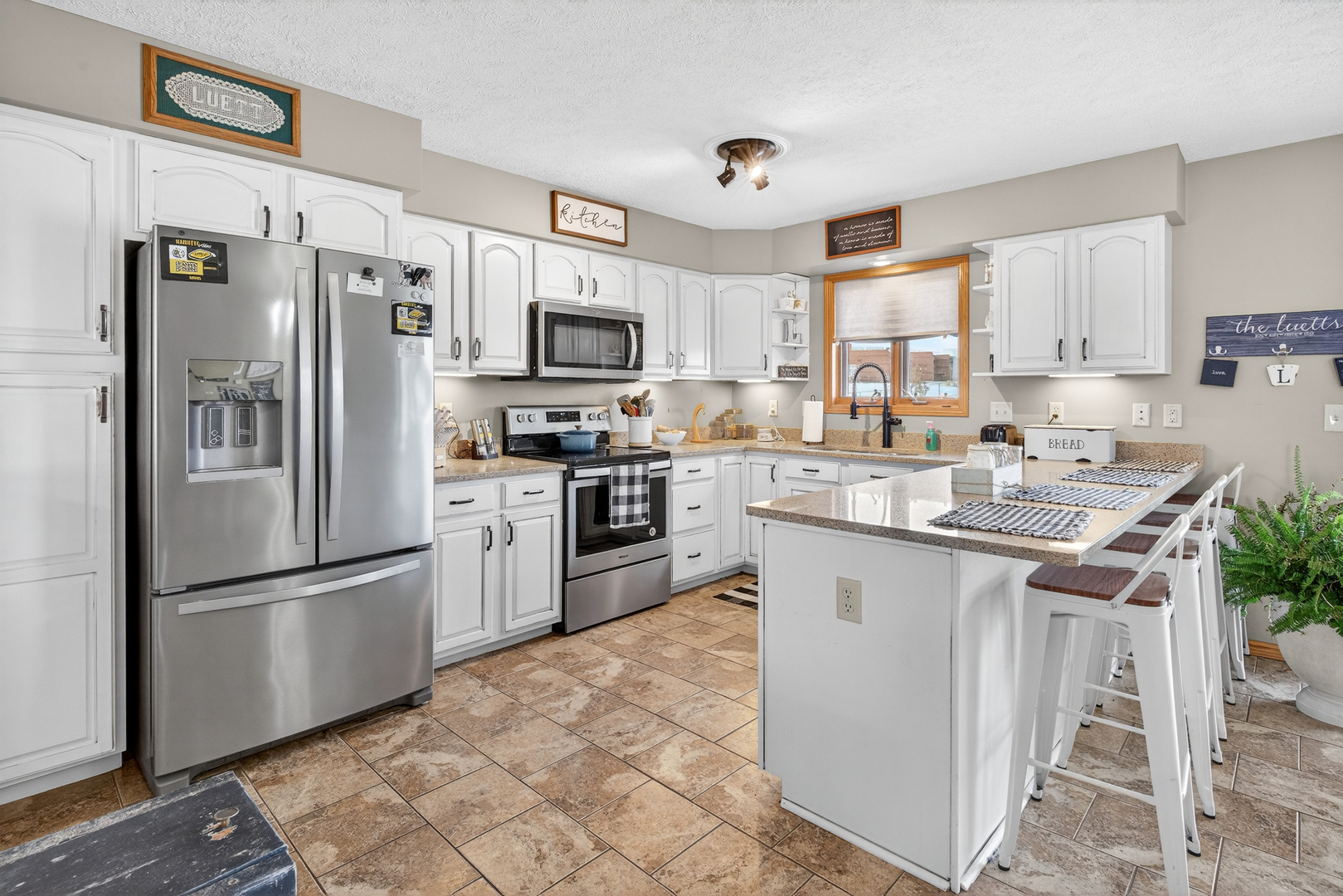 2712 North 13th Street Clinton, IA 52732 - Photo 14 of 47 a kitchen with stainless steel appliances granite countertop a refrigerator stove microwave and sink