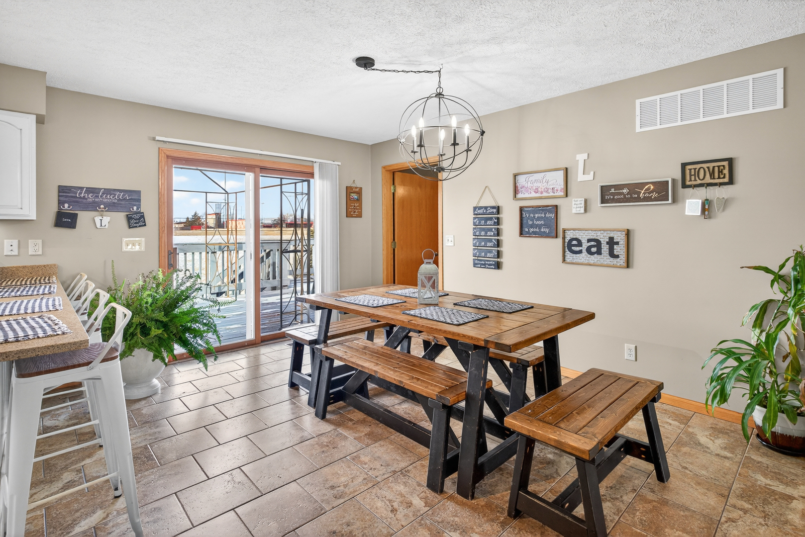 2712 North 13th Street Clinton, IA 52732 - Photo 17 of 47 a living room with a table chairs and a potted plant