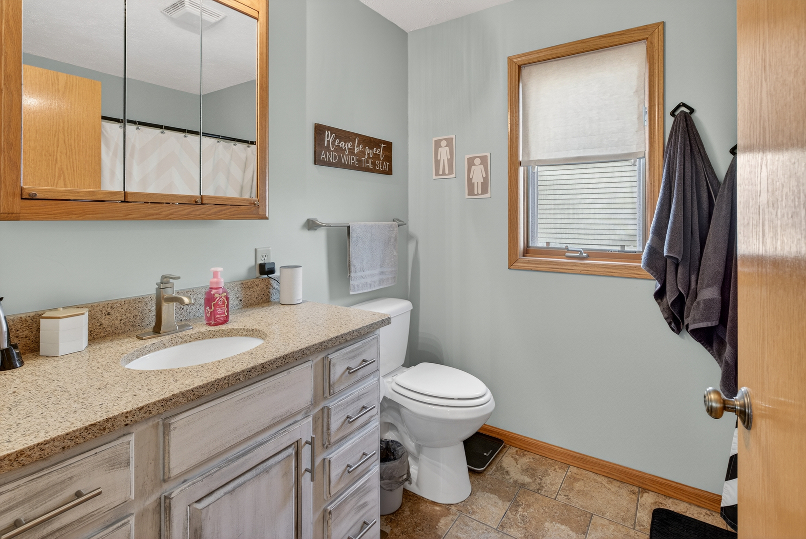 2712 North 13th Street Clinton, IA 52732 - Photo 20 of 47 a bathroom with a granite countertop toilet sink and mirror