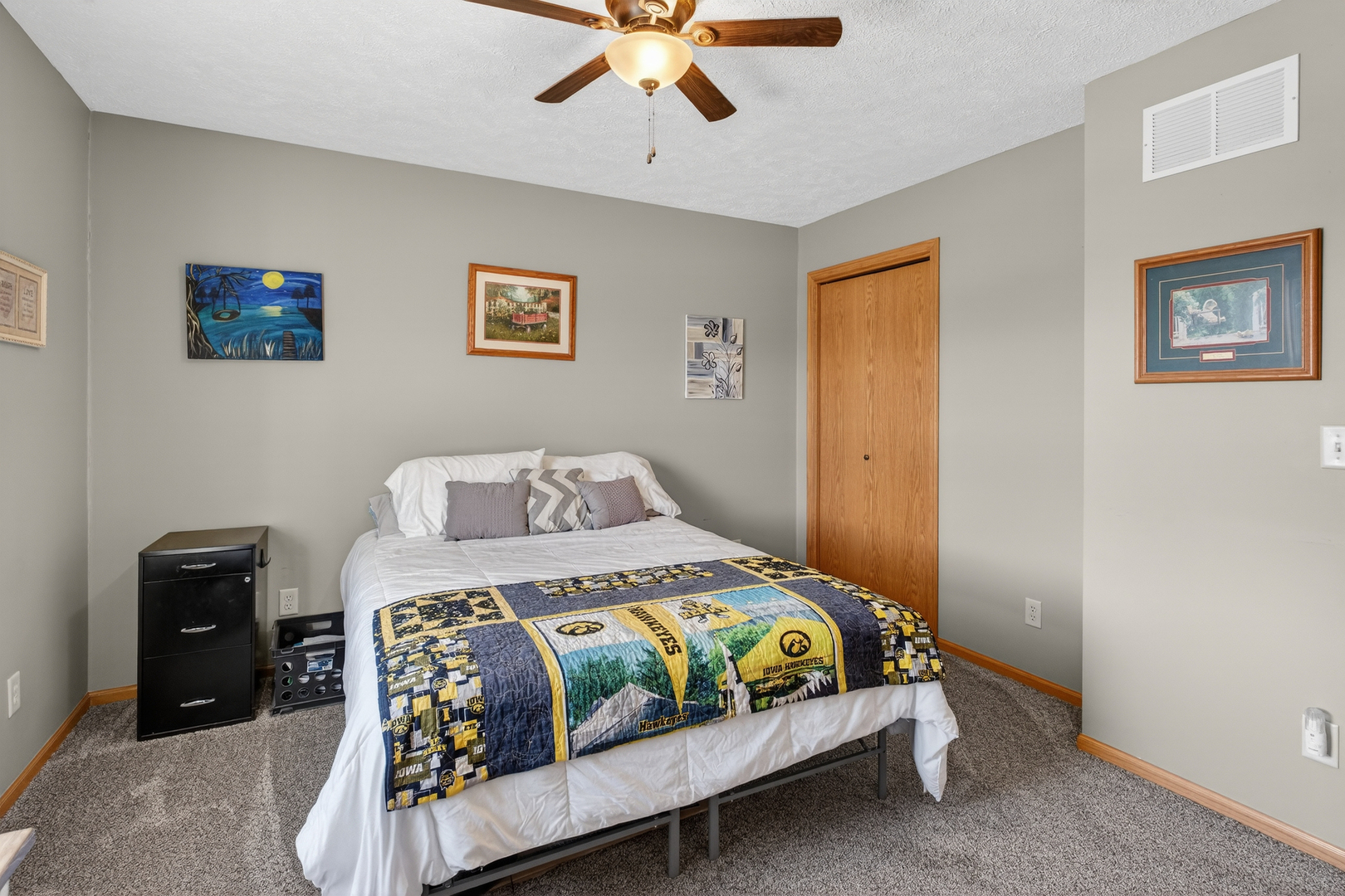 2712 North 13th Street Clinton, IA 52732 - Photo 29 of 47 a bedroom with a bed and a chandelier